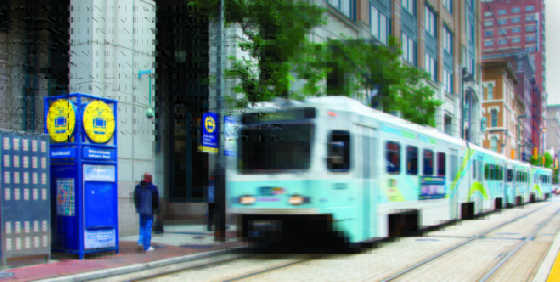blurred photo of light rail train in downtown Baltimore
