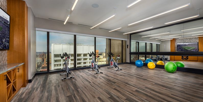 photo of 2Hopkins apartments' fitness center spin room with a row of spin bikes in front of windows