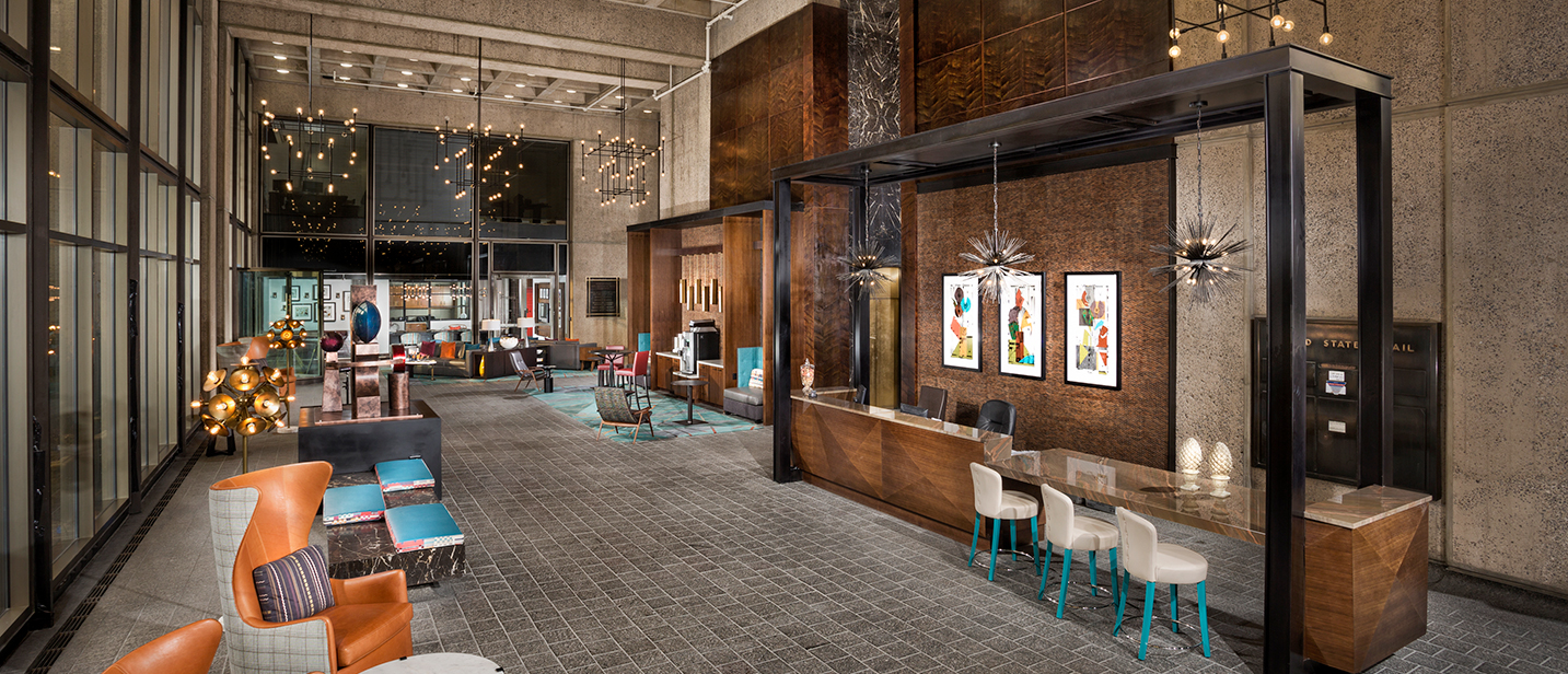 2Hopkins Apartments clubhouse lobby with seating and reception desk - Baltimore, MD