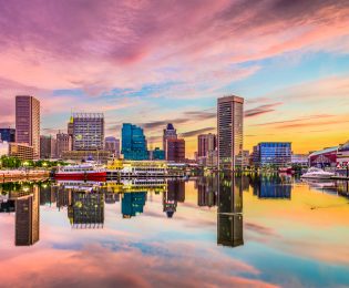 sunset photo of Inner Harbor Baltimore showing vivid colors of blues, pinks, oranges and reds